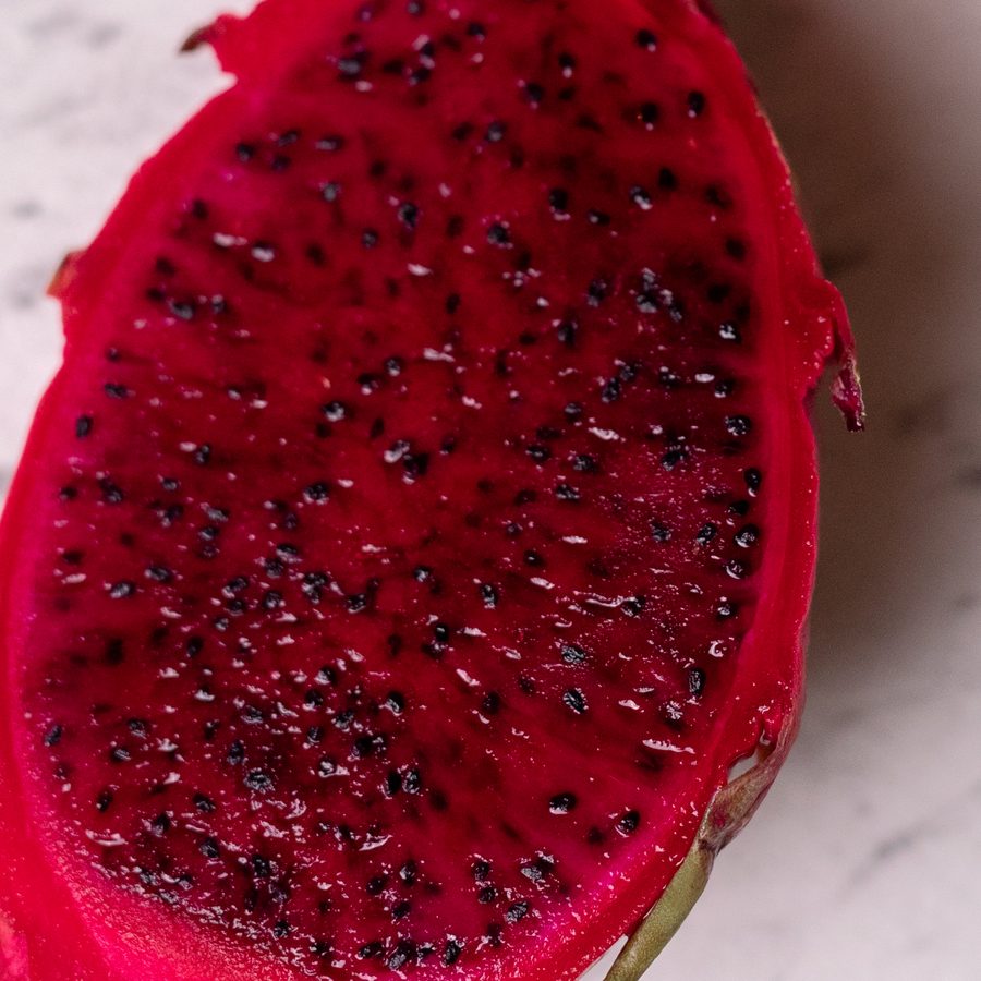 A halved red dragon fruit